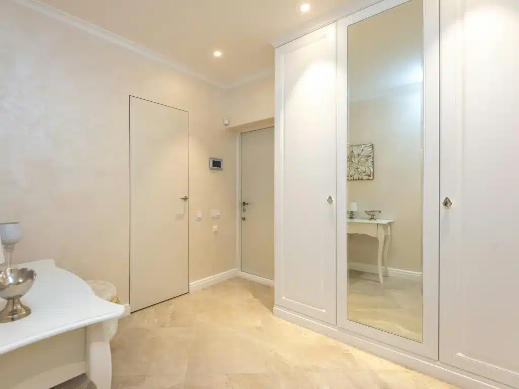 view of bedroom wardrobe with mirror installment